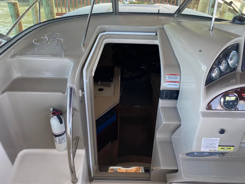 Slide: The Image of 2008 Sea Ray 270 Amberjack cabin entrance with dashboard and fire extinguisher. - 11