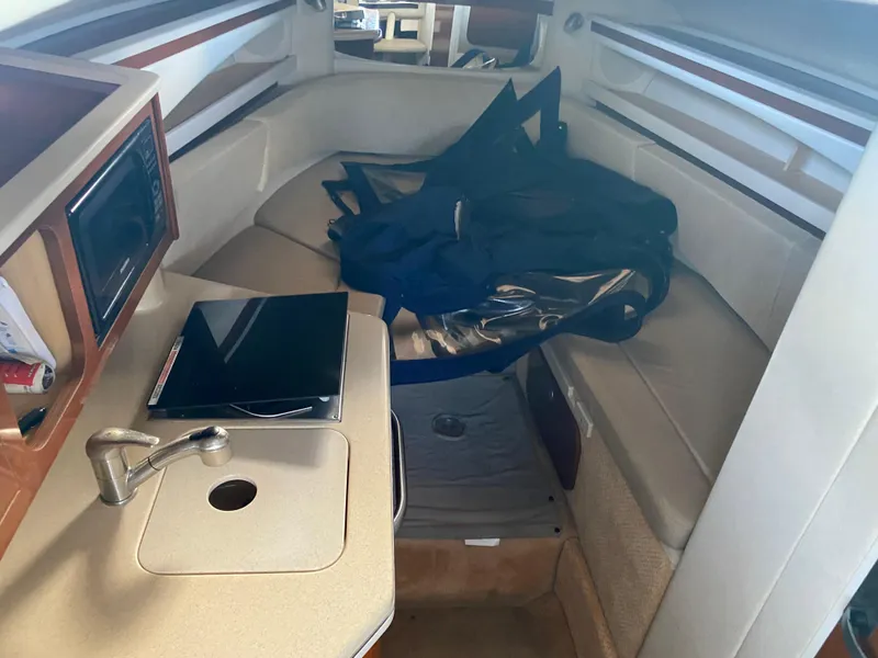 Slide: The Image of Interior cabin of 2008 Sea Ray 270 Amberjack with seating and kitchenette. - 12