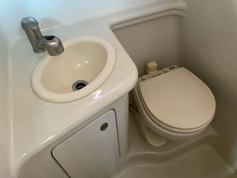 Slide: The Image of Compact bathroom in 2008 Sea Ray 270 Amberjack boat with sink and toilet. - 22