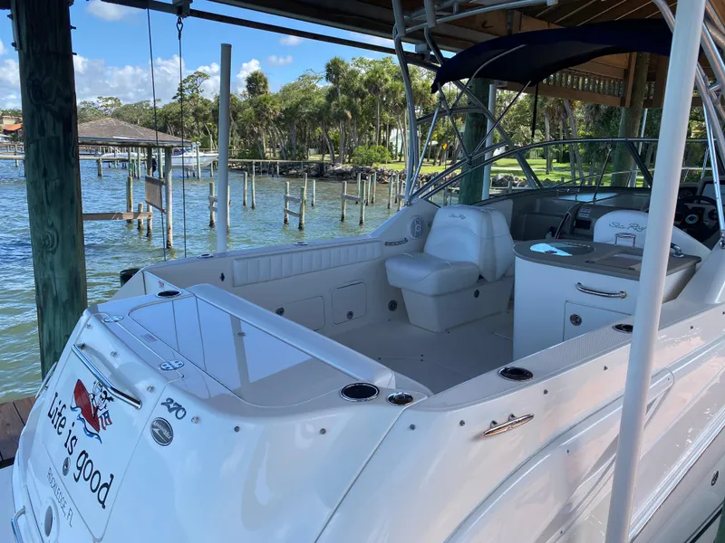 Slide: The Image of 2008 Sea Ray 270 Amberjack boat docked, featuring spacious seating and scenic waterfront view. - 4