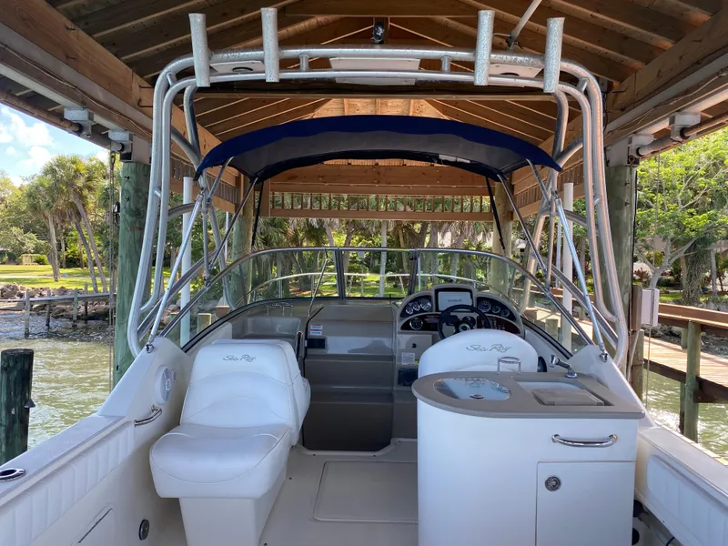 Slide: The Image of 2008 Sea Ray 270 Amberjack boat interior with helm and seating under a wooden canopy. - 5