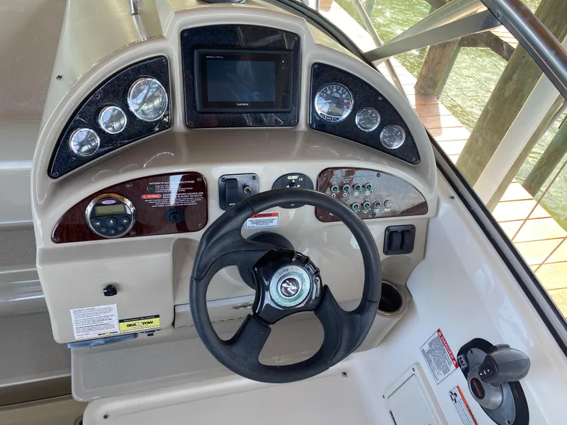 Slide: The Image of Dashboard of a 2008 Sea Ray 270 Amberjack boat with steering wheel and gauges. - 9