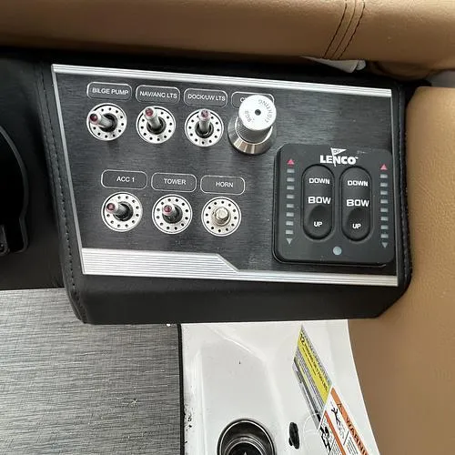 Slide: The Image of Control panel of 2023 Four Winns HD3 boat with switches and Lenco trim tab controls. - 36