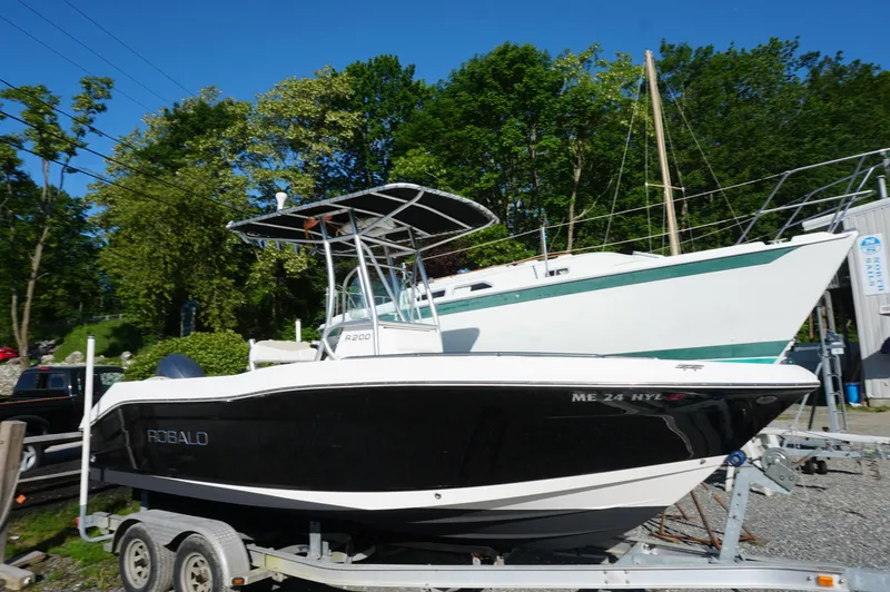 The Image of 2012 Robalo R200 Center Console boat on trailer, parked outdoors. - 0
