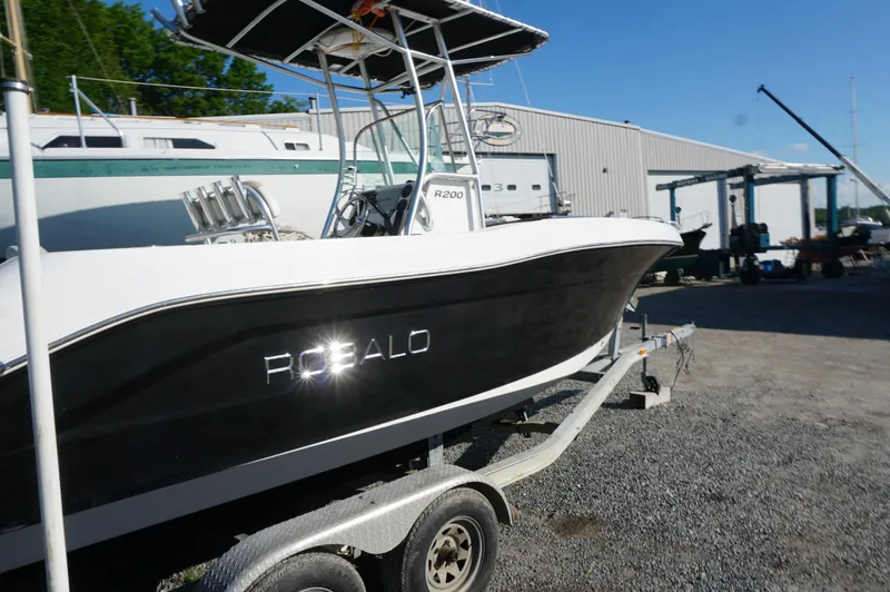 Slide: The Image of 2012 Robalo R200 Center Console boat on trailer in marina setting. - 12