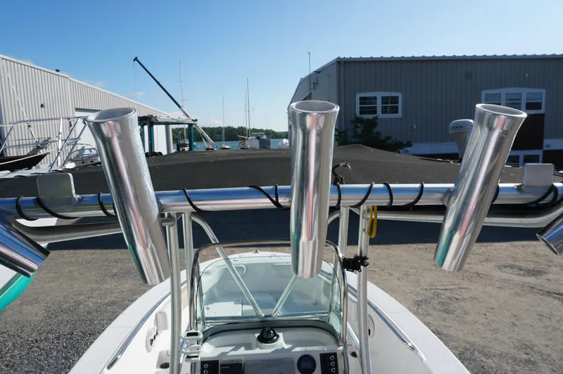 Slide: The Image of 2012 Robalo R200 Center Console boat with rod holders, docked near a marina. - 16