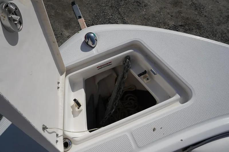 Slide: The Image of Open anchor storage compartment on 2012 Robalo R200 Center Console boat. - 18