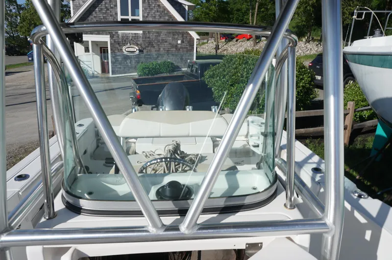 Slide: The Image of 2012 Robalo R200 Center Console boat with stainless steel frame and clear windshield. - 24