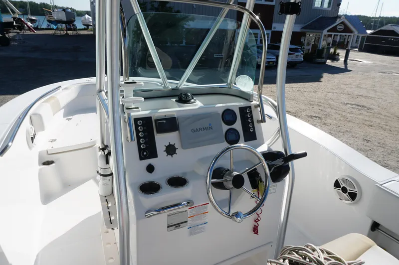 Slide: The Image of 2012 Robalo R200 Center Console boat interior with steering wheel and Garmin navigation system. - 32