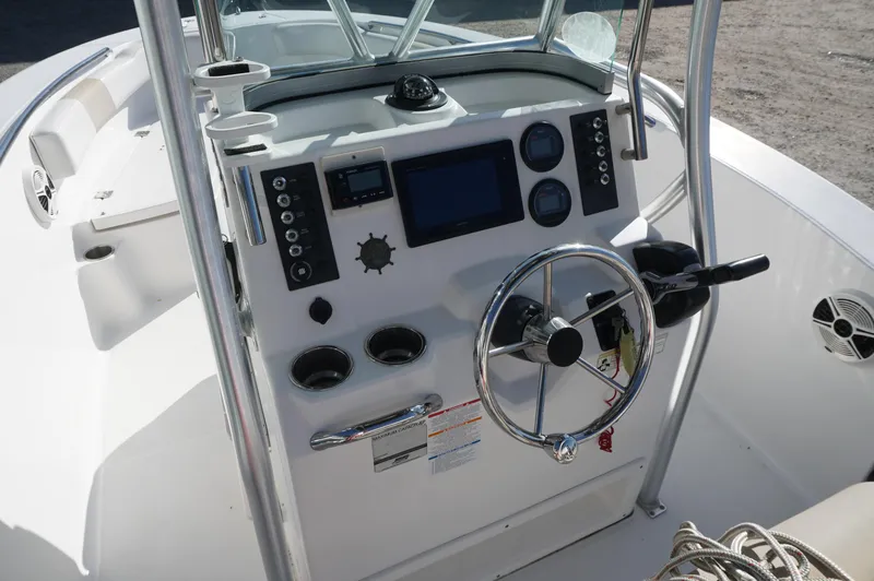 Slide: The Image of 2012 Robalo R200 Center Console boat dashboard with steering wheel and controls. - 34