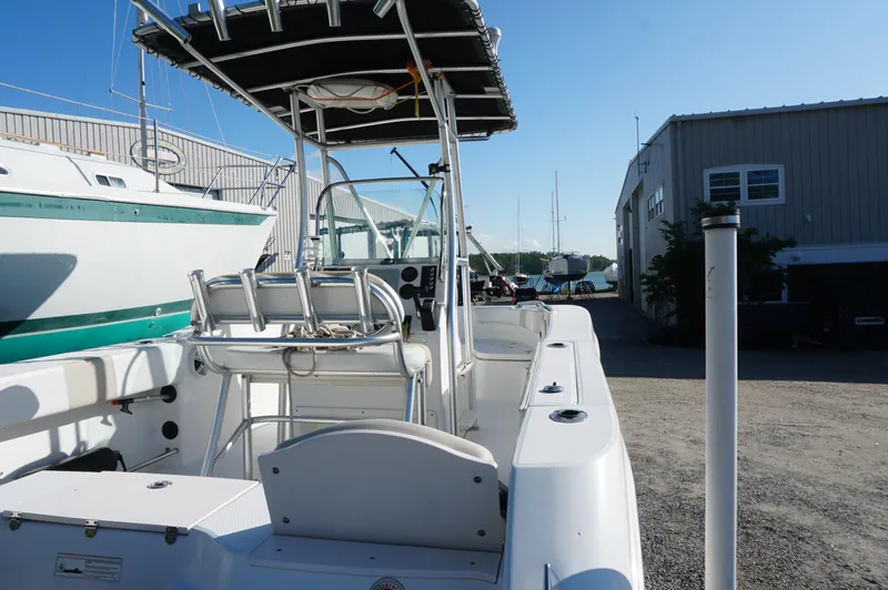 Slide: The Image of 2012 Robalo R200 Center Console boat docked near a marina, under clear blue skies. - 39