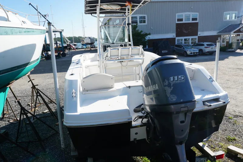 Slide: The Image of 2012 Robalo R200 Center Console boat with Yamaha 115 engine in a marina setting. - 4