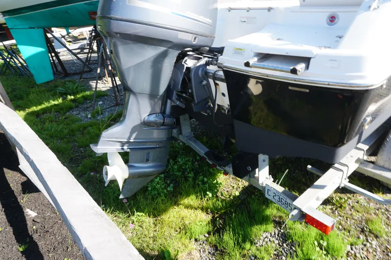 Slide: The Image of 2012 Robalo R200 Center Console boat on trailer, showing outboard motor and hull. - 5