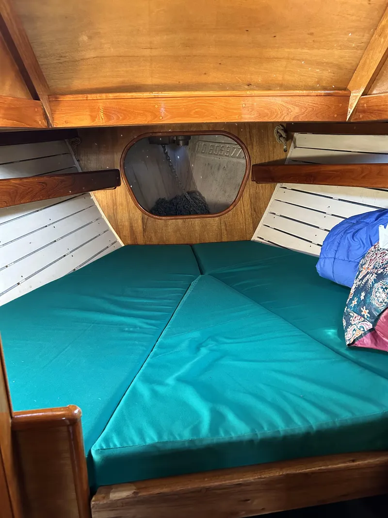 Slide: The Image of Interior cabin of a 1979 Cape George 36 sailboat with green cushions. - 14