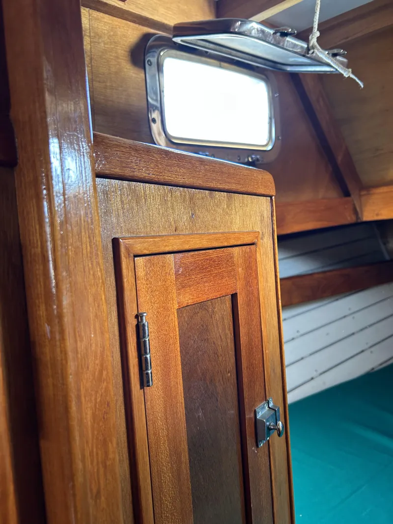 Slide: The Image of Interior of 1979 Cape George 36 sailboat with wooden cabinetry and open porthole. - 15