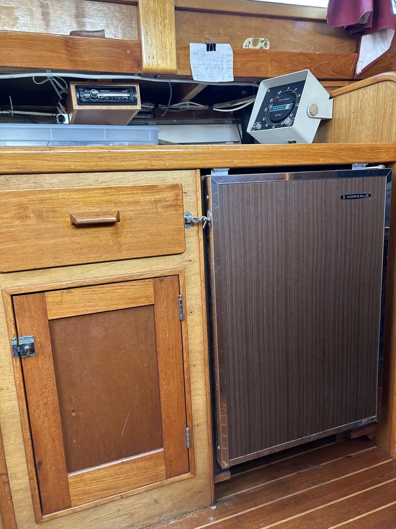 Slide: The Image of Wooden interior of a 1979 Cape George 36 sailboat with a Norcold refrigerator. - 17