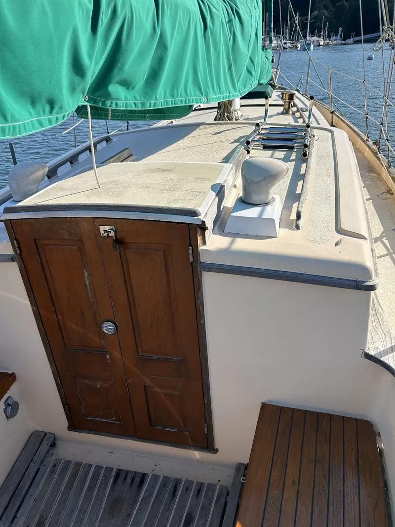 Slide: The Image of 1979 Cape George 36 sailboat deck with wooden doors and green cover. - 2