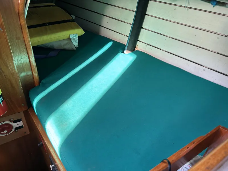 Slide: The Image of Interior cabin of 1979 Cape George 36 sailboat with teal bedding. - 21