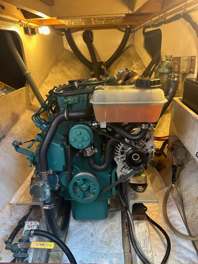 Slide: The Image of Engine compartment of a 1979 Cape George 36 sailboat, showcasing detailed mechanical components. - 22