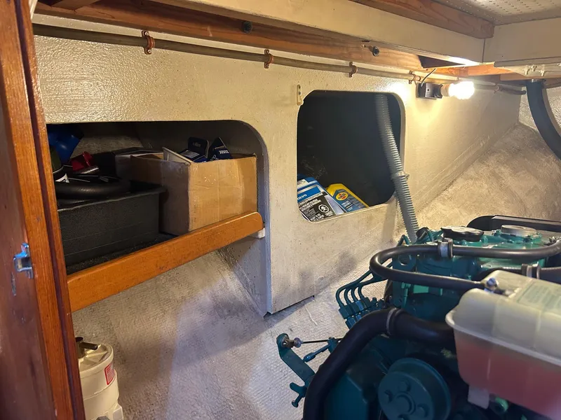 Slide: The Image of Engine room of a 1979 Cape George 36 sailboat with storage shelves. - 23