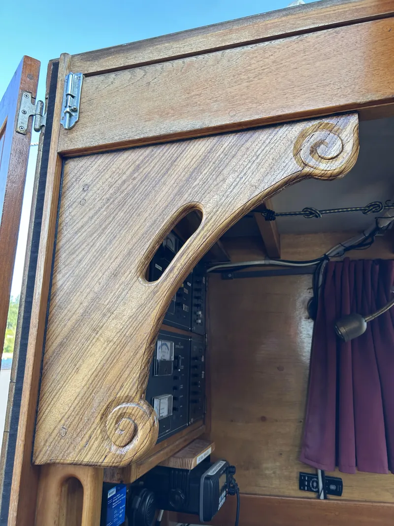 Slide: The Image of Wooden interior detail of a 1979 Cape George 36 sailboat, featuring intricate craftsmanship. - 3