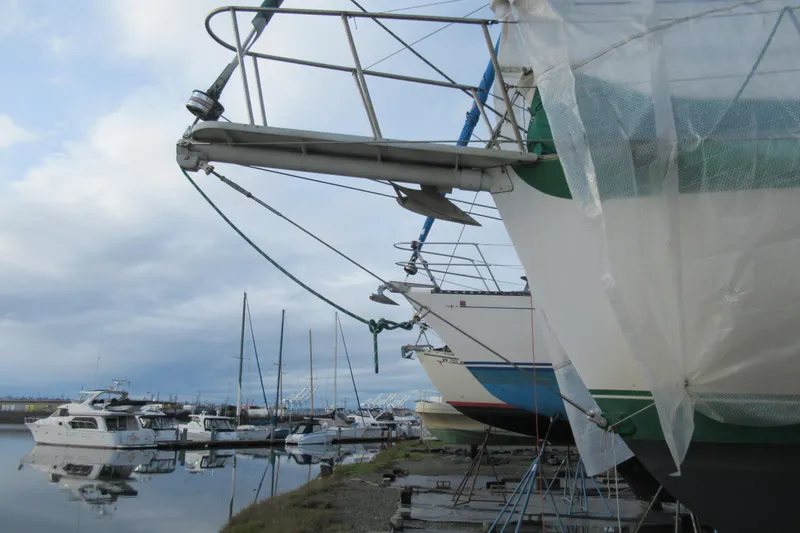 Slide: The Image of Boats docked at a marina, featuring a 1979 Cape George 36 sailboat. - 30