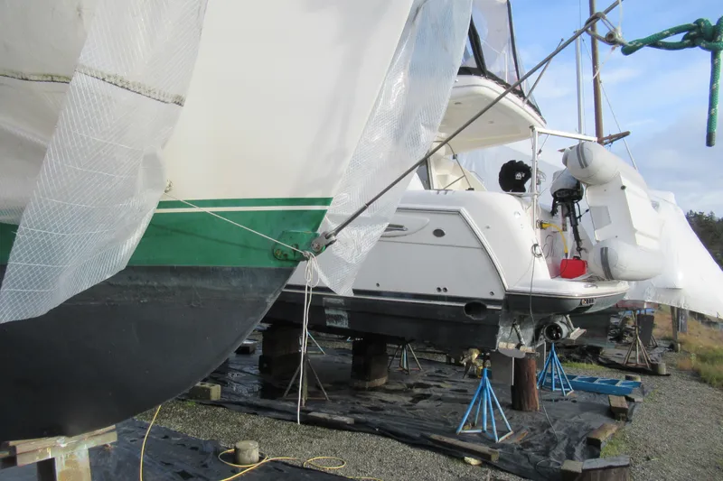 Slide: The Image of Cape George 36 sailboat from 1979, covered and elevated for maintenance. - 36
