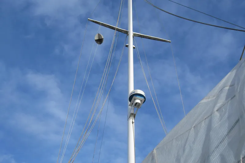 Slide: The Image of Mast of 1979 Cape George 36 sailboat against a clear blue sky. - 38