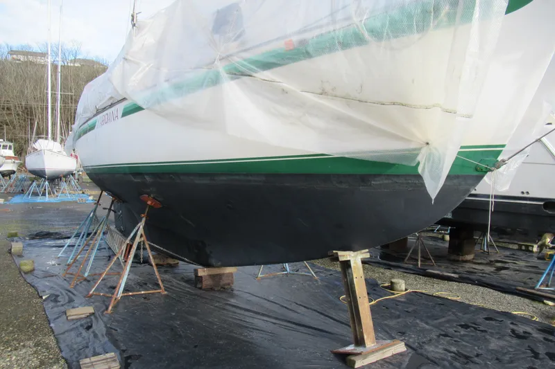 Slide: The Image of 1979 Cape George 36 sailboat on stands, covered for maintenance. - 40