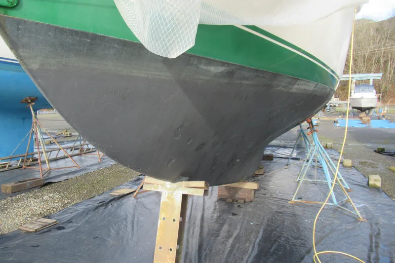 Slide: The Image of 1979 Cape George 36 sailboat hull on stands, undergoing maintenance. - 42