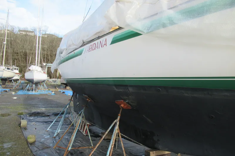 Slide: The Image of 1979 Cape George 36 sailboat on stands, undergoing maintenance in a boatyard. - 43
