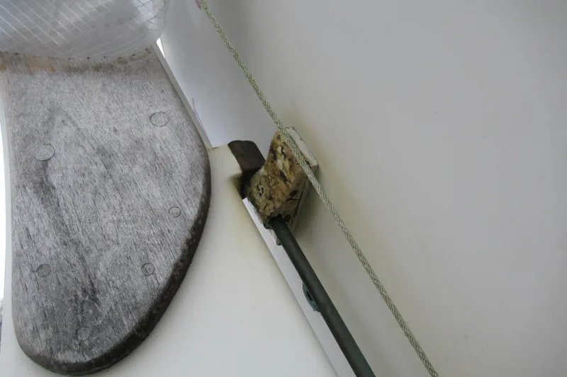 Slide: The Image of Wooden deck detail on 1979 Cape George 36 sailboat with rope and metal fitting. - 47