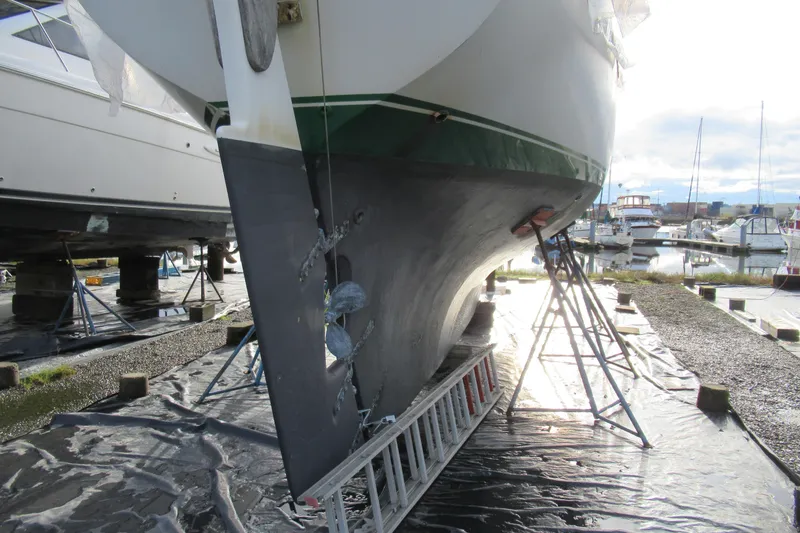 Slide: The Image of Cape George 36 sailboat from 1979 on stands in a marina, undergoing maintenance. - 48
