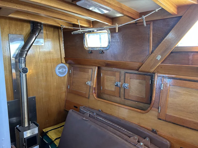 Slide: The Image of Interior of 1979 Cape George 36 sailboat with wood paneling and stove. - 5