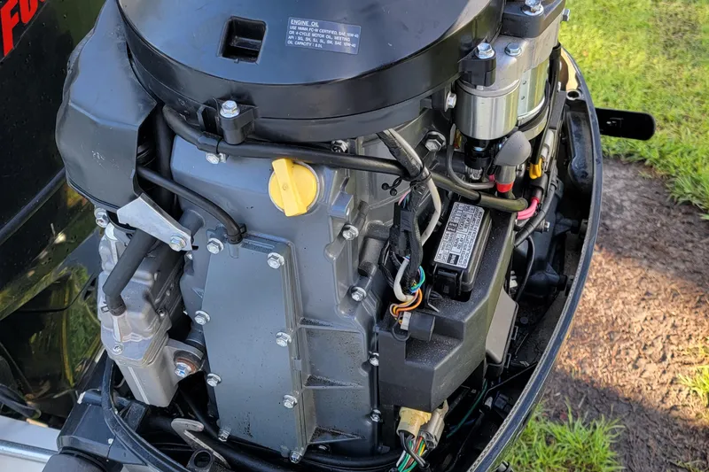 Slide: The Image of Close-up of a 2012 Carolina Skiff 24 engine, showcasing detailed components and wiring. - 7