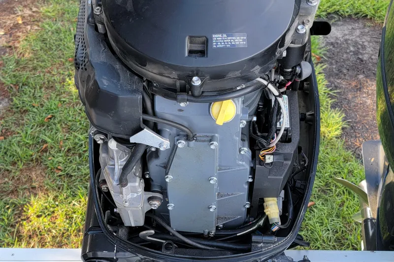 Slide: The Image of Close-up of a 2012 Carolina Skiff 24 outboard motor on grass. - 8