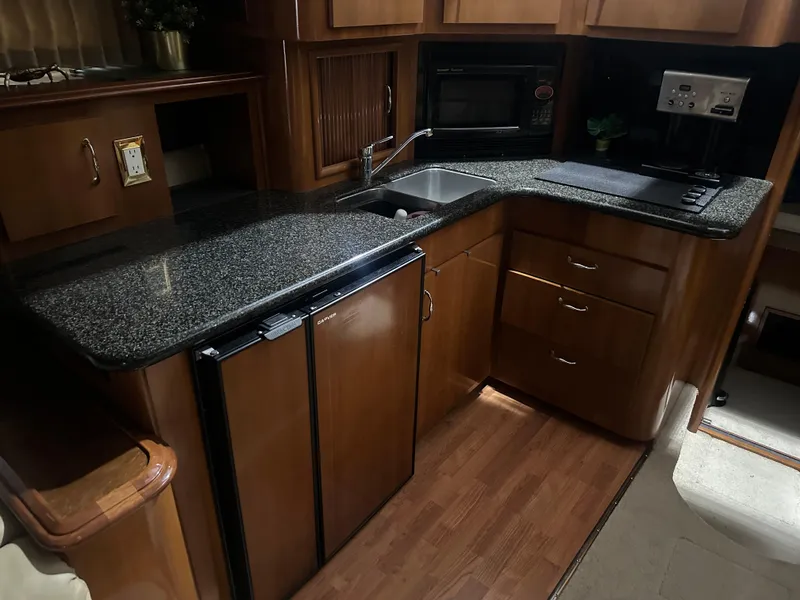 Slide: The Image of Luxurious kitchen in 2005 Carver 44 CMY yacht with granite countertops and modern appliances. - 2