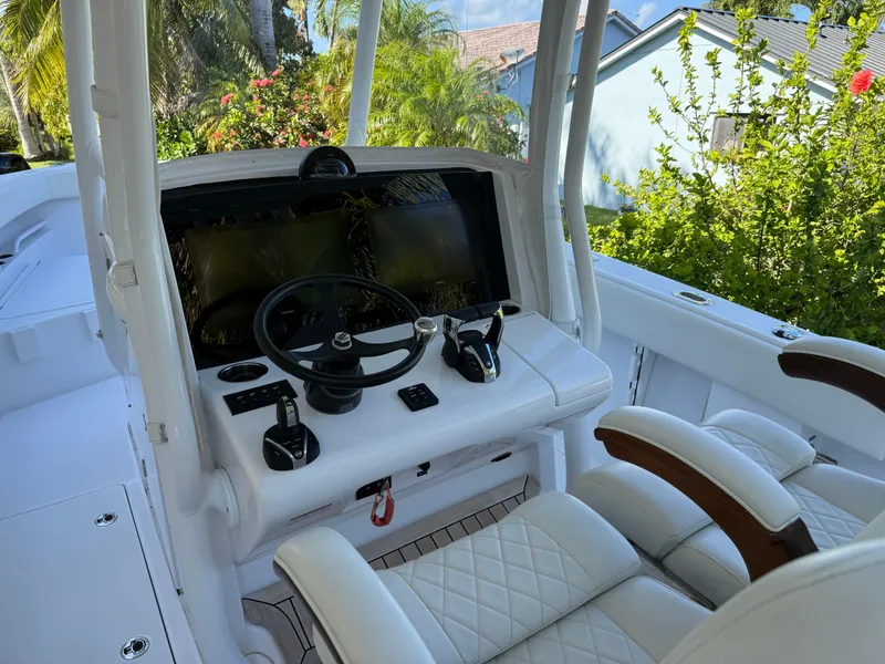Slide: The Image of Luxurious 2023 Jupiter 30 boat cockpit with modern steering and controls. - 5