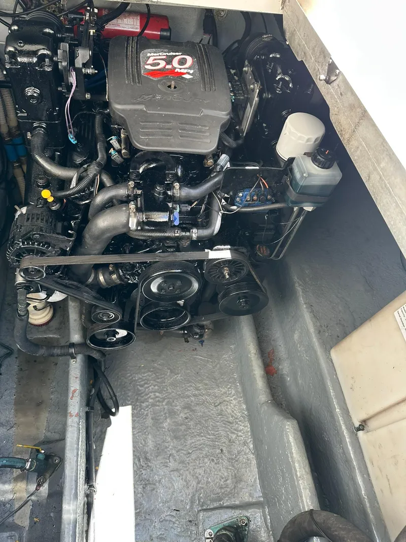 Slide: The Image of Engine compartment of a 2003 Sea Ray 290 Amberjack boat, featuring a 5.0 MerCruiser engine. - 18