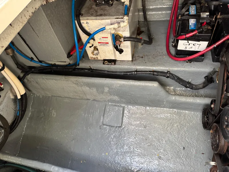 Slide: The Image of Engine compartment of 2003 Sea Ray 290 Amberjack with visible wiring and battery. - 22