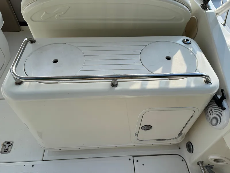 Slide: The Image of 2003 Sea Ray 290 Amberjack boat interior with storage compartment and stainless steel railing. - 6