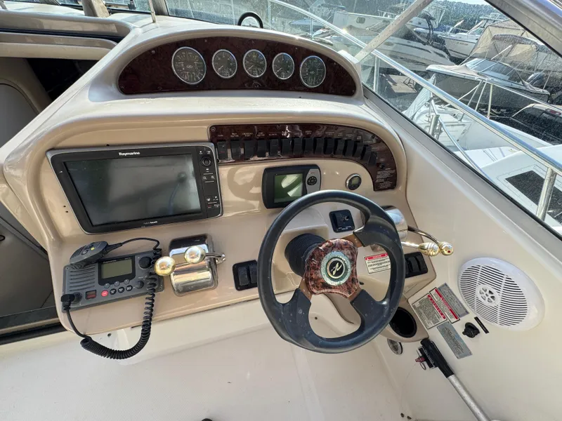 Slide: The Image of 2003 Sea Ray 290 Amberjack helm with steering wheel, gauges, and navigation equipment. - 8