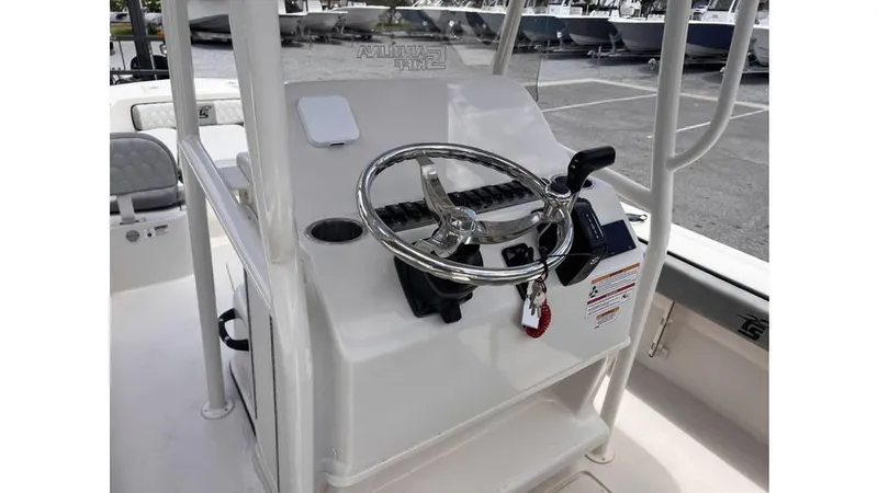 Slide: The Image of 2025 Carolina Skiff 24 Ultra Elite boat console with steering wheel and controls. - 7