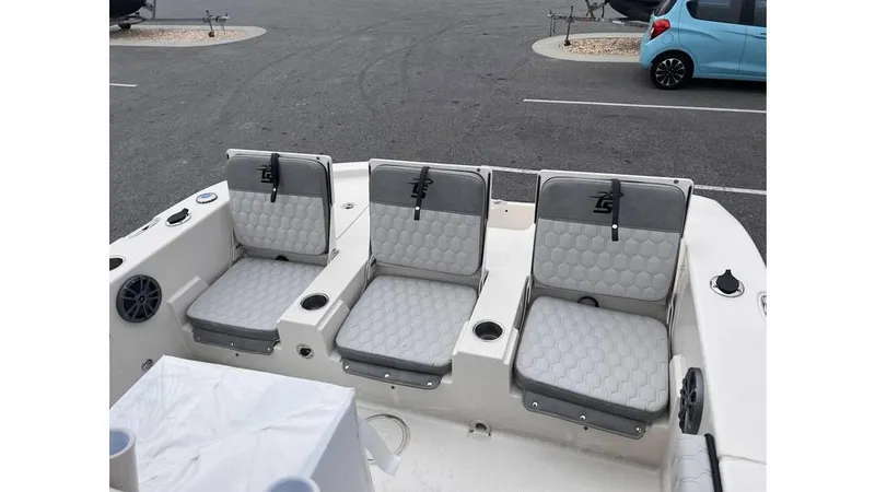 Slide: The Image of 2025 Carolina Skiff 24 Ultra Elite boat seats in a parking lot. - 13