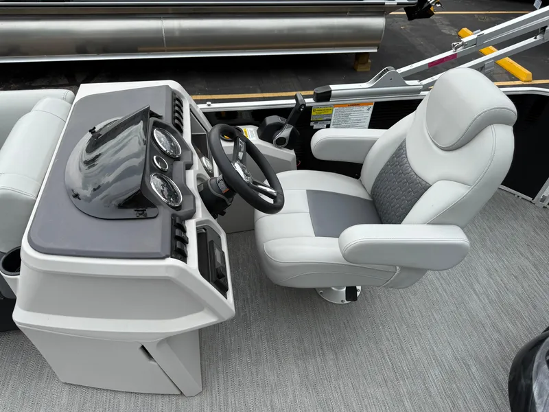 Slide: The Image of Captain's seat and dashboard of 2023 Godfrey Sweetwater boat, featuring modern controls and gauges. - 11