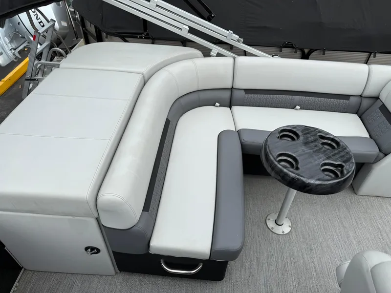 Slide: The Image of 2023 Godfrey Sweetwater boat interior with gray seating and a round table. - 17