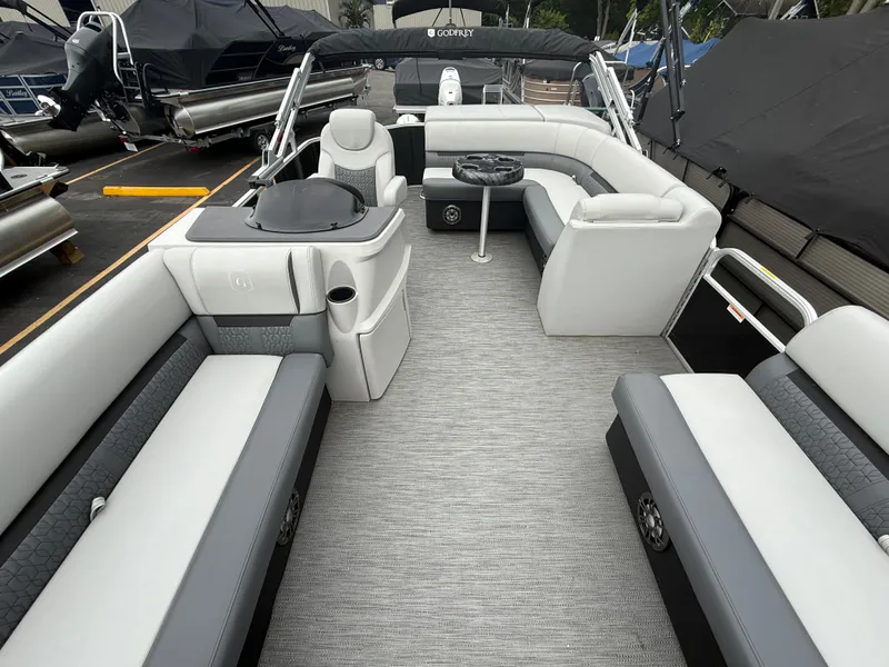 Slide: The Image of 2023 Godfrey Sweetwater pontoon boat interior with luxurious seating and modern design. - 7