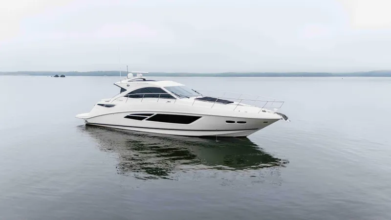 The Image of 2013 Sea Ray 510 Sundancer yacht on calm water, showcasing sleek design and luxury features. - 0