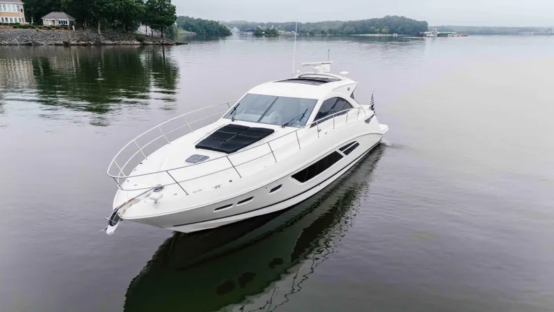 Slide: The Image of 2013 Sea Ray 510 Sundancer yacht cruising on a calm lake. - 13