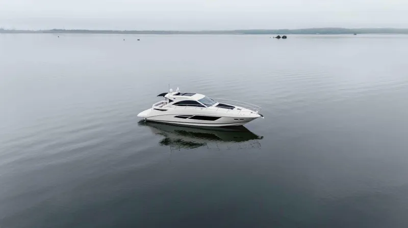 Slide: The Image of 2013 Sea Ray 510 Sundancer yacht on calm water, overcast sky. - 15